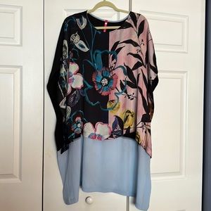Elegant never worn blouse with longer back.